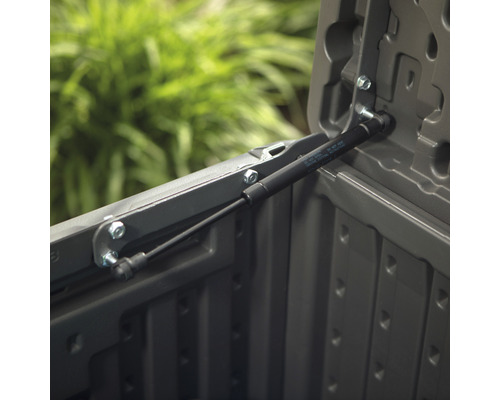 Detailweergave van een gasveer op een grijze opbergbox.