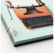 Decoratieve afbeelding van een oranje typemachine met papier en een prop papier