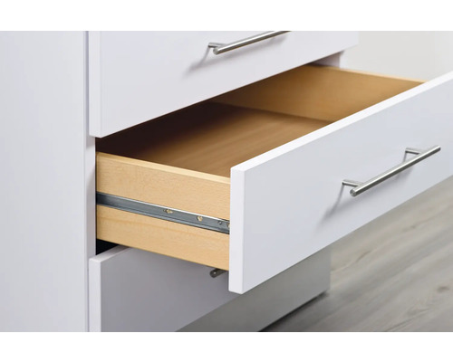 Witte ladekast met een open lade.
