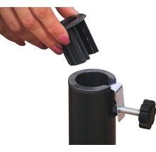 Detailopname van een zwarte buis met klem en een hand die een plastic onderdeel plaatst