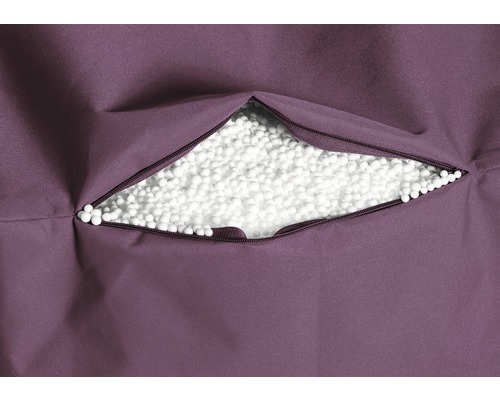 Close-up van een open rits in een zitzak, gevuld met witte polystyreenkorrels.