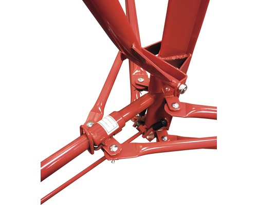 Detailopname van een rode steigerbasis met metalen stutten en verbindingsstukken