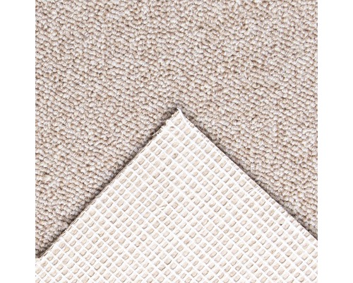 Detail van een beige tapijt met antisliprug.