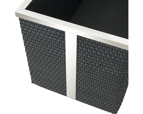 Detailopname van een plantenbak met gevlochten textuur en metalen rand