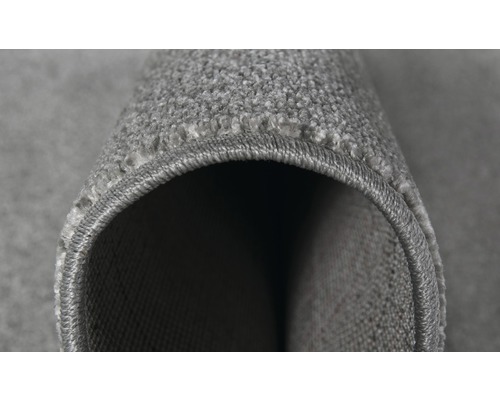 Detailopname van een grijs tapijt met festonranden