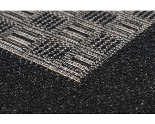 Detailopname van een tapijt met een geometrisch patroon