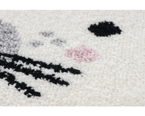 Detailopname van een tapijt met een dierengezichtmotief