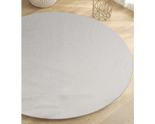 Rond vloerkleed op houten vloer
