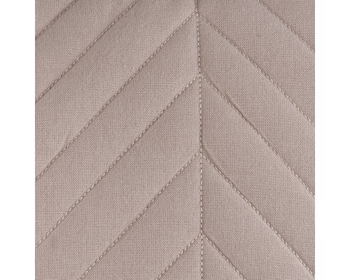 Close-up van gewatteerde stof met V-vormig patroon.