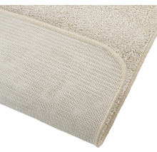 Detailopname van een beige tapijt met antislip achterkant