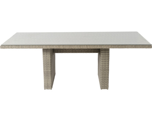 Eettafel met glazen blad en rotanstructuur