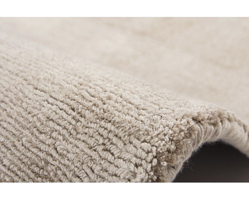 Detailopname van een beige tapijt met structuur