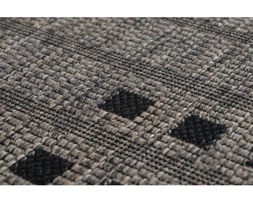 Detailopname van een getuft tapijt met motief