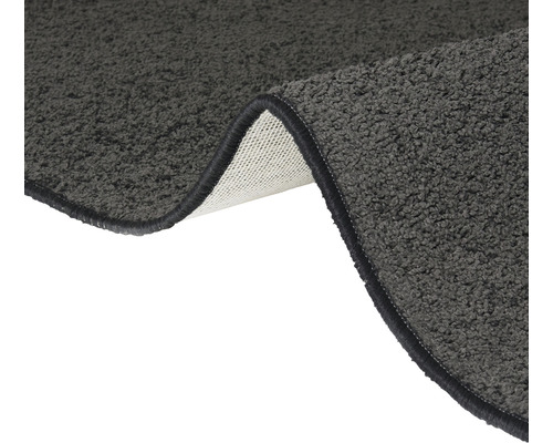 Detailweergave van een grijs shaggy tapijt met gekettelde randen
