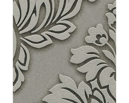 Detailopname van een vinylbehang met reliëf en bloemmotief.