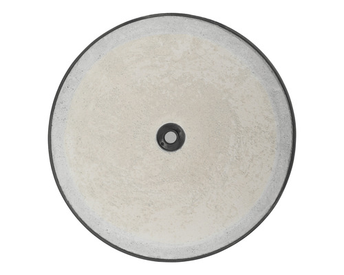 Ronde betonnen wastafel van bovenaf met afvoer