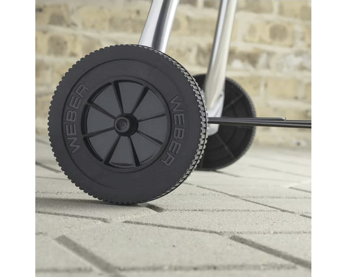 Gedetailleerde opname van een Weber-barbecue met wielen voor eenvoudig transport.