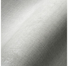Close-up van lichtgekleurd behang met subtiele textuur.