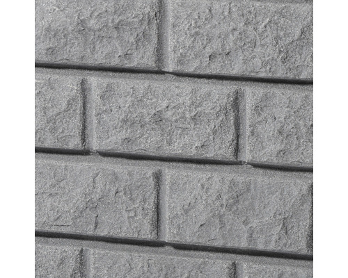 Close-up van een grijze steenwandbekleding in baksteenmotief