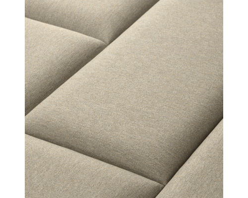 Close-up van een beige bank met gestikt oppervlak