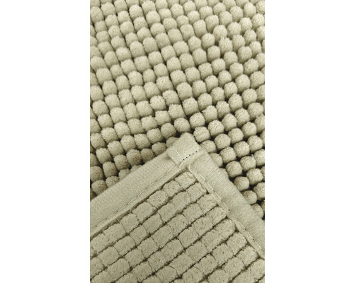 Detailweergave van een badmat met nopjesstructuur en ingesloten randen