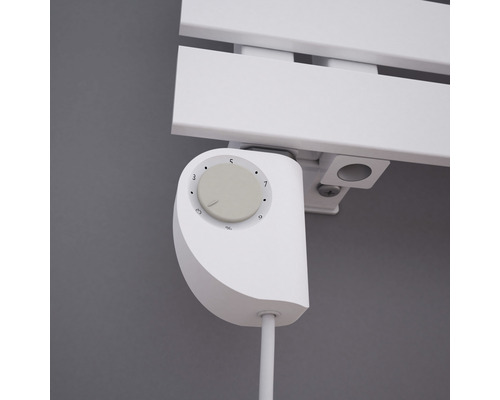 Detailopname van een witte radiatorthermostaat op een radiator