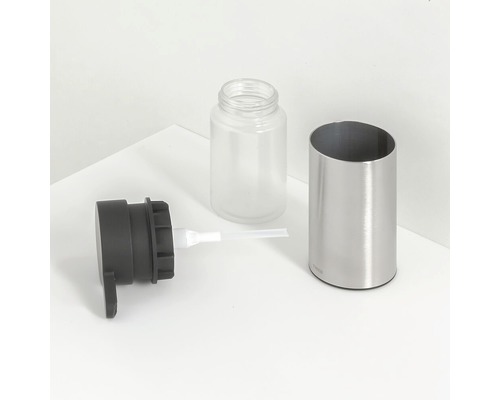Gedemonteerde zeepdispenser van metaal, kunststof en glas
