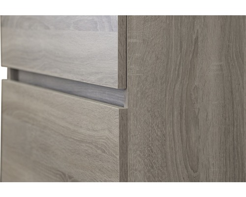 Detailweergave van een meubel met houten structuur en laden