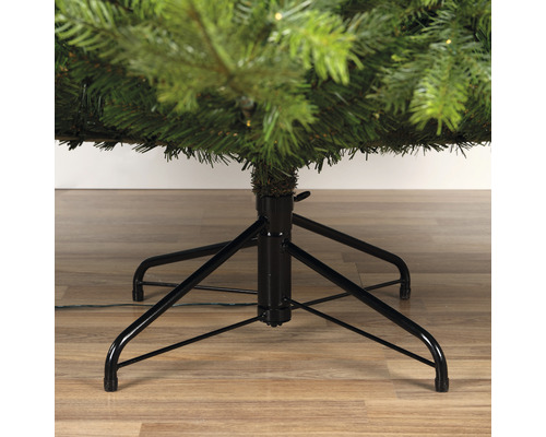 Detail van een kerstboom met zwarte metalen voet