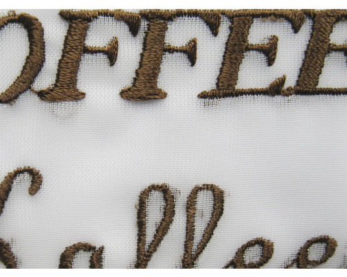 Detail van geborduurde stof met het woord koffie
