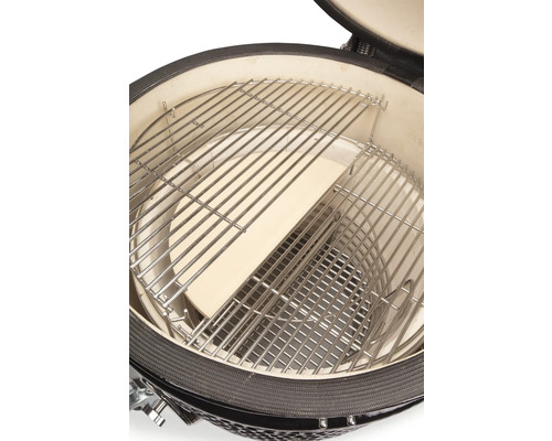 Binnenaanzicht van een keramische grill met grillrooster en pizzasteen