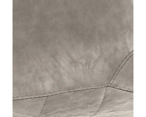 Detailopname van een gestoffeerd meubelstuk met gewatteerd oppervlak