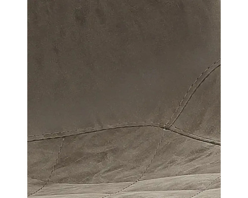 Close-up van een gewatteerde stoffering met sierstiksels