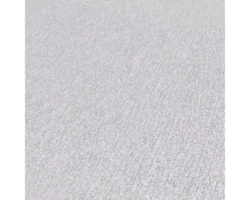 Close-up van een lichtkleurig vliesbehang met een fijne structuur