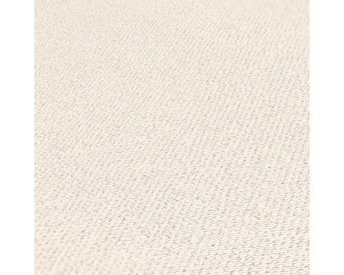 Close-up van een lichte textieloppervlakte met fijne structuur