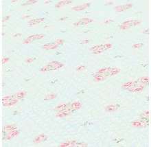 Close-up van een tafelkleed met rozenmotief