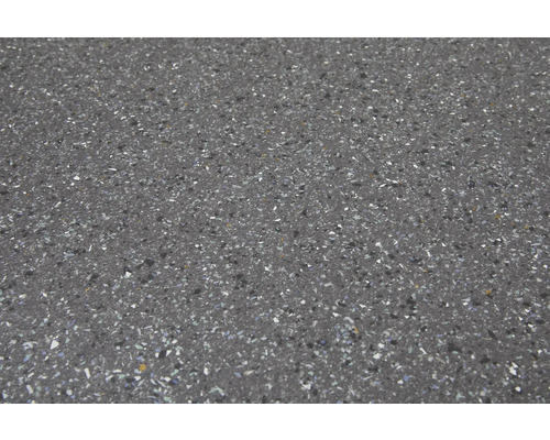 Close-up van een vloertegel met een gespikkelde afwerking