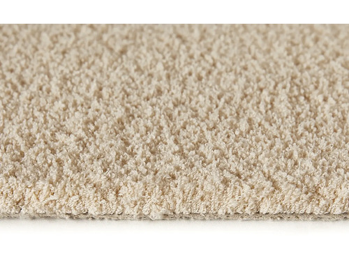 Close-up van een beige tapijt met lussenstructuur