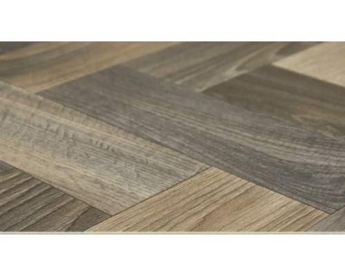 Close-up van een laminaatvloer in visgraatmotief