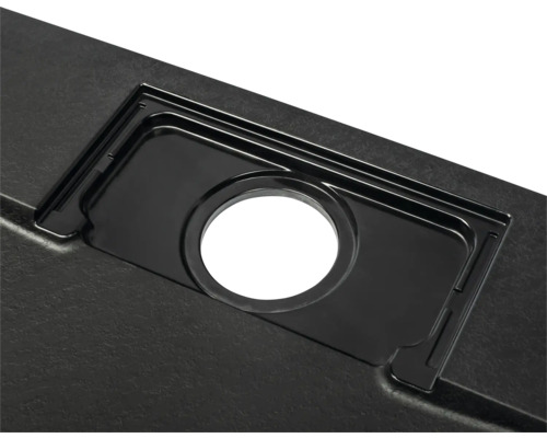 Detailopname van een zwarte gootsteen met afvoergarnituur