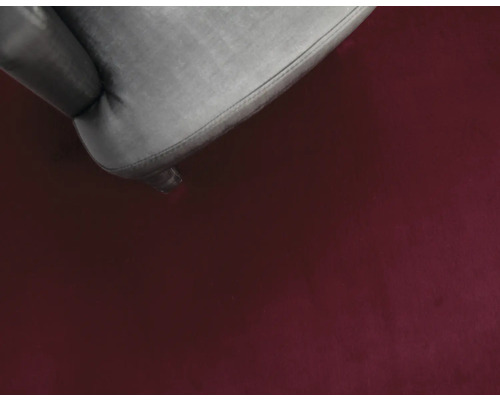 Detailopname van een vloerkleed en een stoelpoot