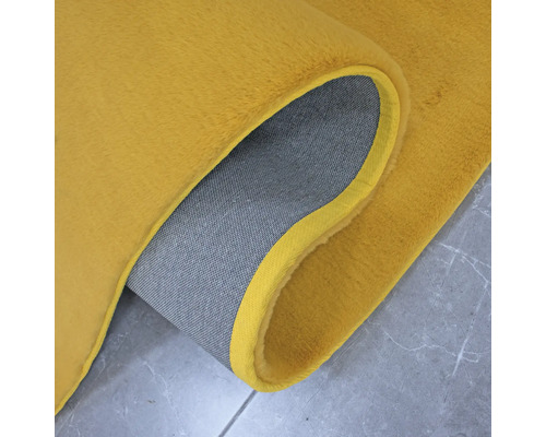 Detailaanzicht van een tapijt met een textielen rug