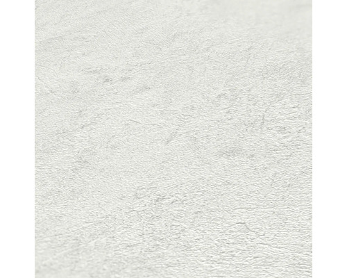 Close-up van een wit vliesbehang met een lichte structuur