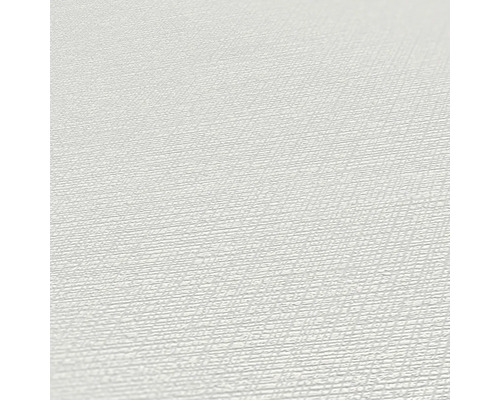 Close-up van een lichtgekleurd behang met fijne structuur