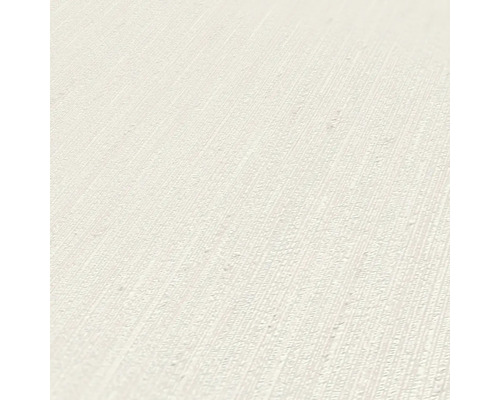 Close-up van een gestructureerd, lichtgekleurd behang