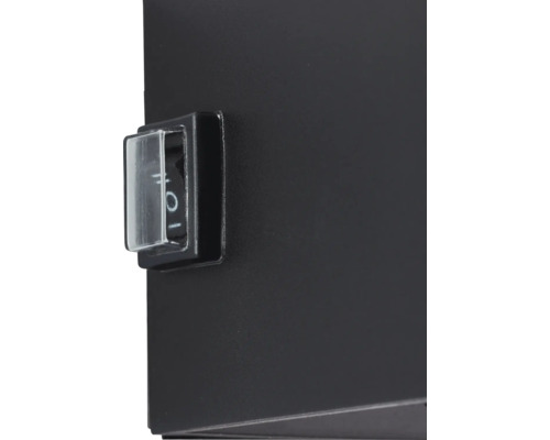 Detail van een zwart apparaat met een schakelaar