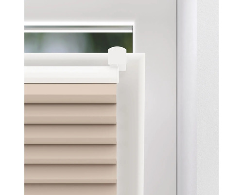 Detail van een plisségordijn op een raam