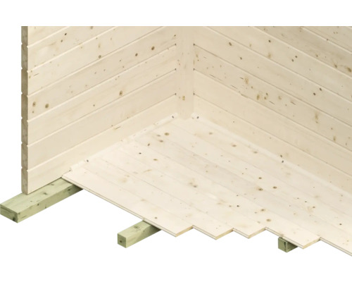 Detailopname van een houten huis met tand- en groefplanken op de wand en vloer