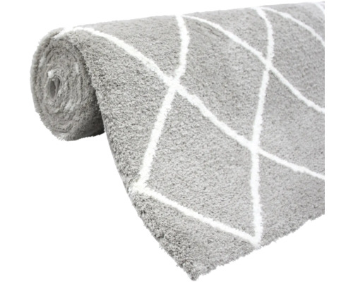 Grijze vloerkleed met ruitpatroon opgerold