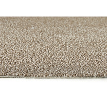 Close-up van een beige tapijt.